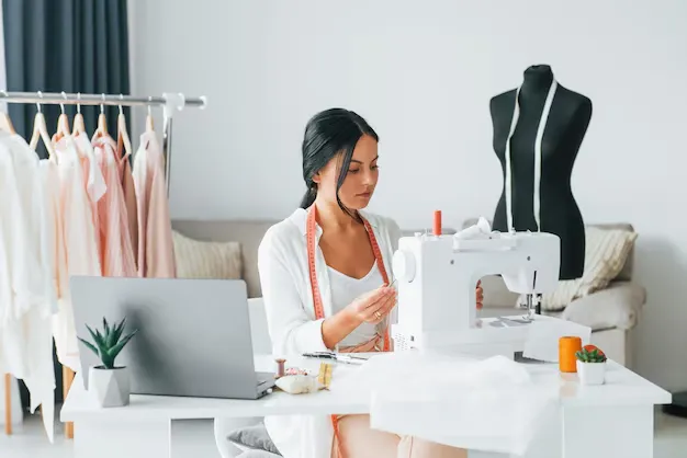 Fashion designer working with sewing machine