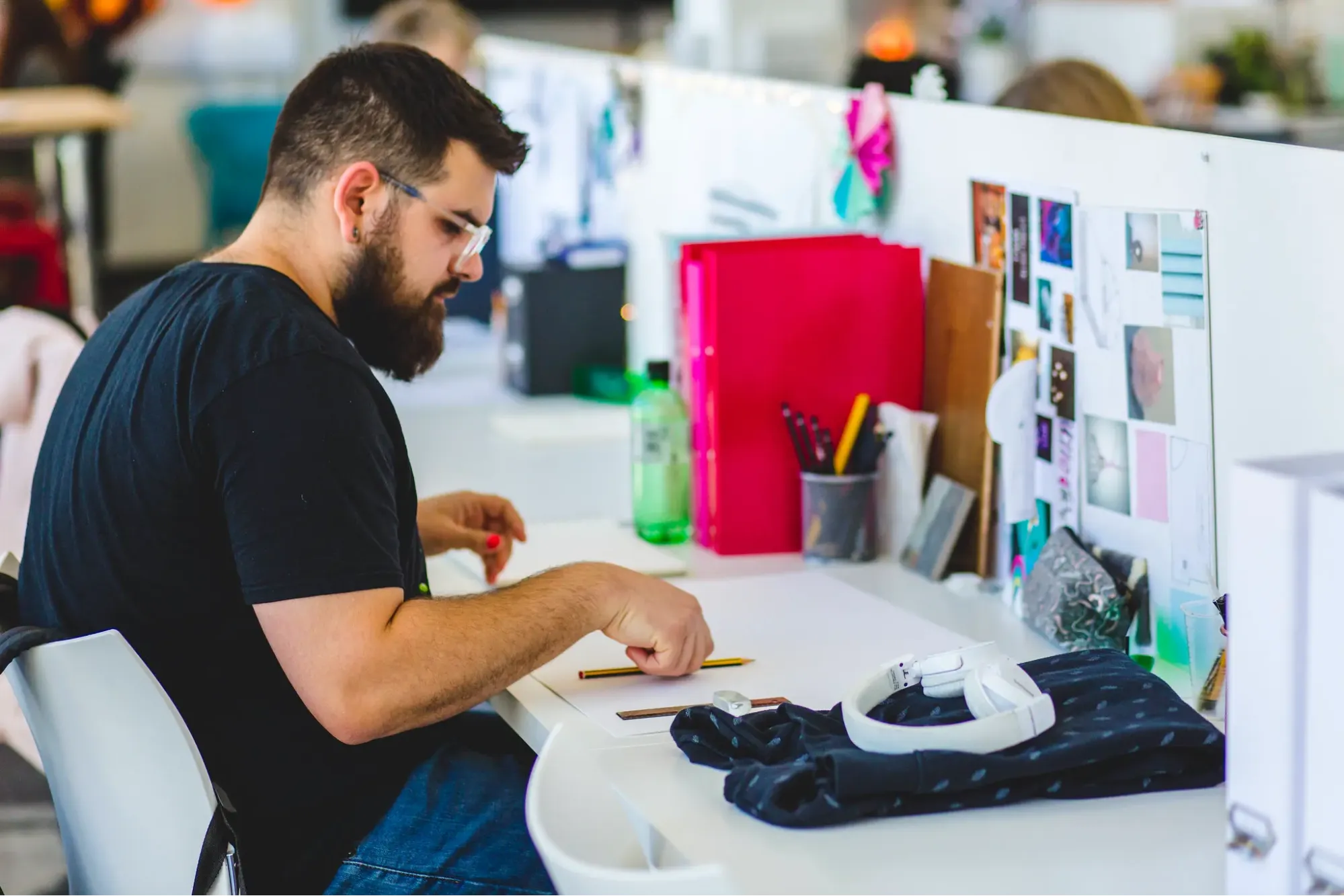 Designer at desk working on projects