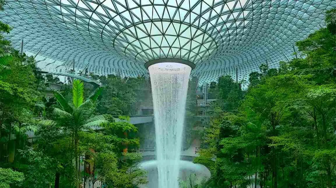 Indoor waterfall surrounded by greenery