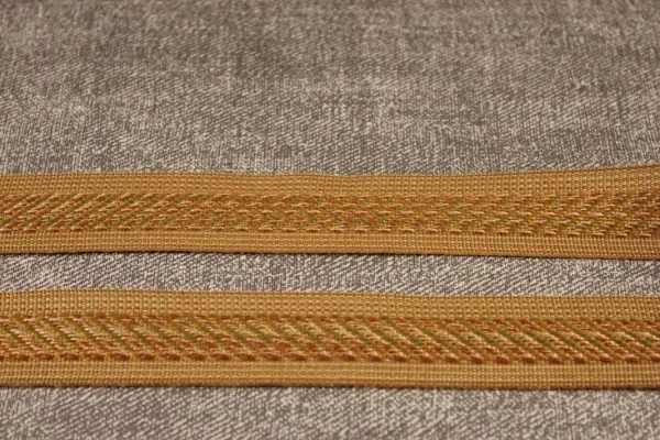 Golden braided trims on textured fabric