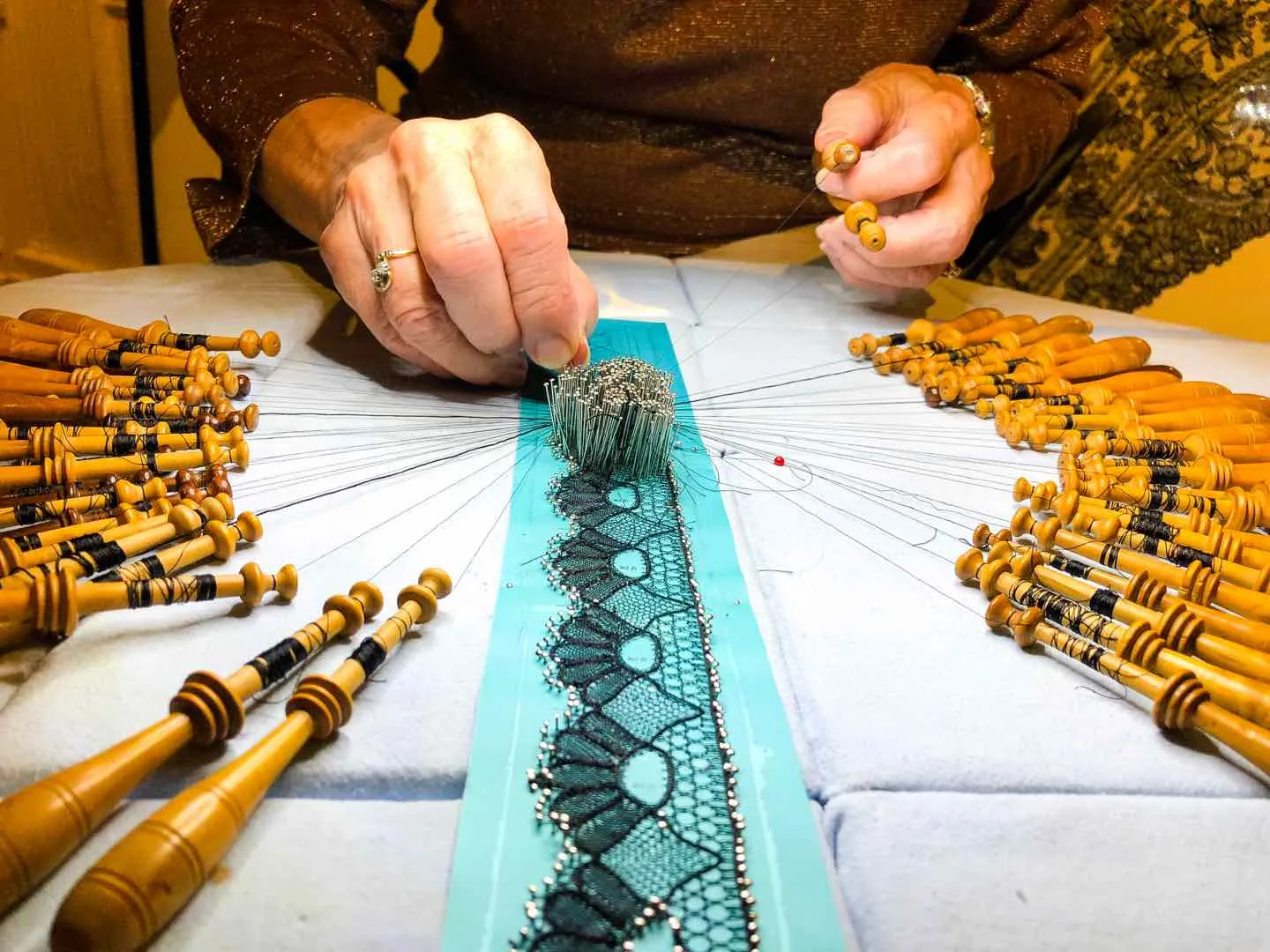 Artisan crafting intricate lace design